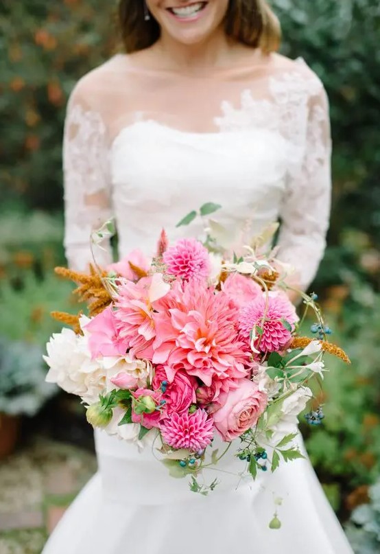 a pink wedding bouquet with dahlias, roses and white dahlias plus berries is a beautiful solution for summer