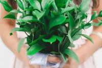 a pretty and simple greenery wedding bouquet with a cute ribbon bow looks very cool