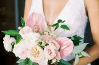 a pretty romantic Valentine wedding bouquet of light pink, blush and white roses, peony roses and tropical blooms plus foliage