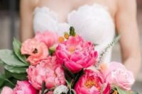 a pretty wedding bouquet with pink, yellow and hot pink flowers and greenery for a spring or summer wedding