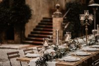 a refined backyard wedding tablescape with neutral linens, neutral blooms and greenery, chic candles and candelabras is amazing