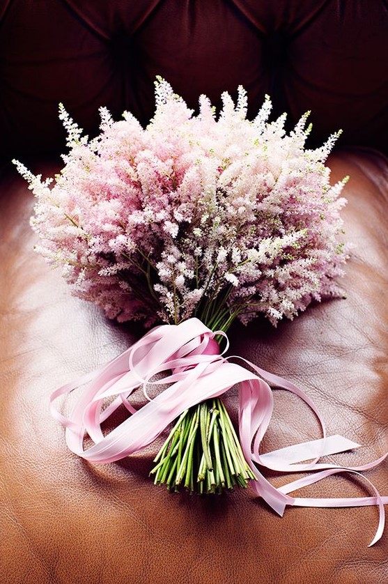 a refined blush astilbe wedding bouquet with pink ribbons is a stylish idea for a delicate bridal look