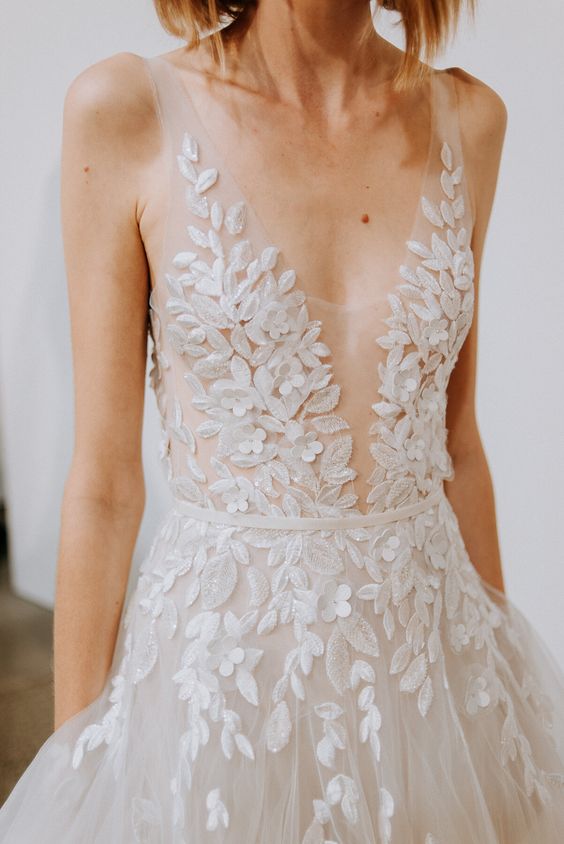 a romantic botanical lace applique wedding dress with straps, an illusion neckline and pockets is a very chic and cool idea