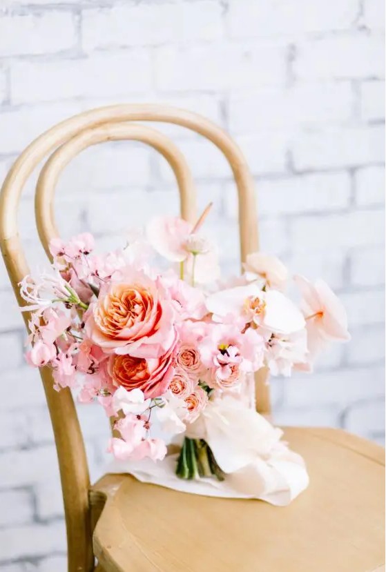 a romantic light pink wedding bouquet with roses and orchids and creamy ribbons is a lovely idea for a Valentine bride