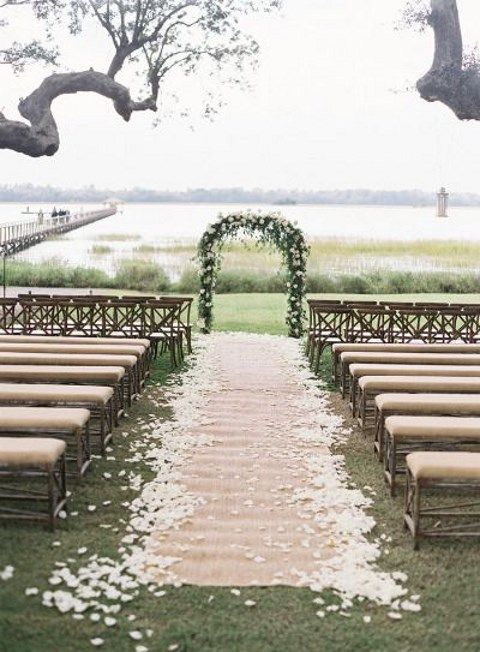a rustic burlap aisle runner paired with petals is a great idea for a rustic celebration