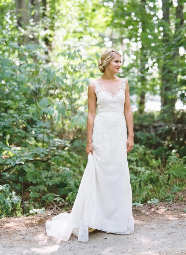 a sleeveless illusion neckline wedding dress with lace appliques, a lace skirt and a train