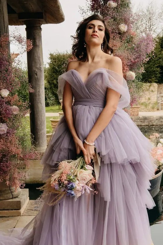 a sophisticated lavender off the shoulder wedding dress with a layered maxi skirt and a sculptural bodice for a garden bride