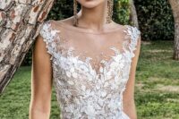a sophisticated wedding ballgown with lace applique, an illusion neckline and cap sleeves is a fantastic idea for a princess-style look