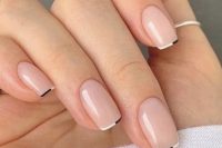 a trendy and delicate French wedding manicure with thin black and white color block tips is a gorgeous solution for modern brides