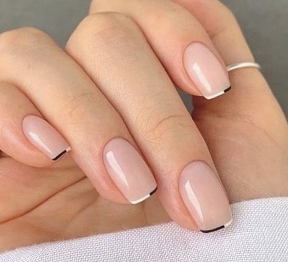 a trendy and delicate French wedding manicure with thin black and white color block tips is a gorgeous solution for modern brides