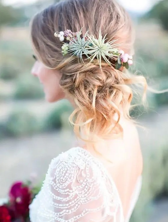 a twisted side updo with waves and airplants is a cool solution because they won't wither
