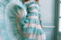 a unique mint ruffle wedding dress with long sleeves and a high neckline is a bold option for a non-traditional bride