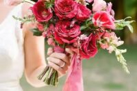 a vibrant wedding bouquet with pink and fuchsia and red blooms and berry-hued ribbons is amazing for a bold wedding