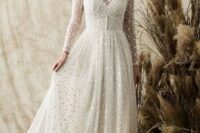 a vintage-inspired polka dot wedding dress with an illusion strapless neckline, long sleeves and a lace trim