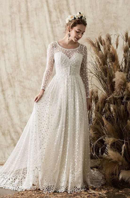 a vintage-inspired polka dot wedding dress with an illusion strapless neckline, long sleeves and a lace trim