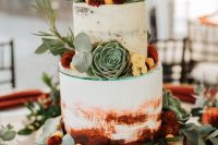 a watercolor burgundy semi-naked wedding cake decorated with bold blooms, greenery and succulents for a bright summer or fall wedding