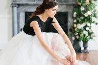 a white full skirt and a black lace applique bodysuit for a bold and contrasting look at the wedding
