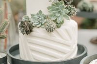 a white geometric wedding cake with succulents and cacti is a stylish idea for any modern wedding