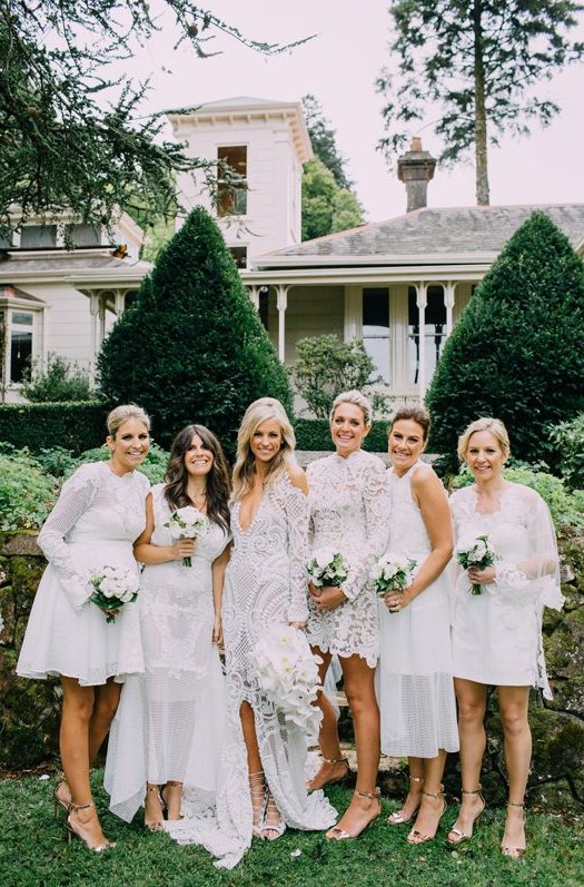 a white mismatched lace bridesmaid dresses and silver shoes for a chic and elegant all-white wedding in summer