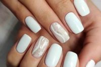 a white wedding manicure with a single blush nail with stars, curves and a bit of glitter is a lovely idea for spring