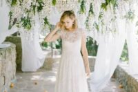 an ethereal short sleeve wedding dress with a sweetheart neckline, lace appliques and a lace skirt