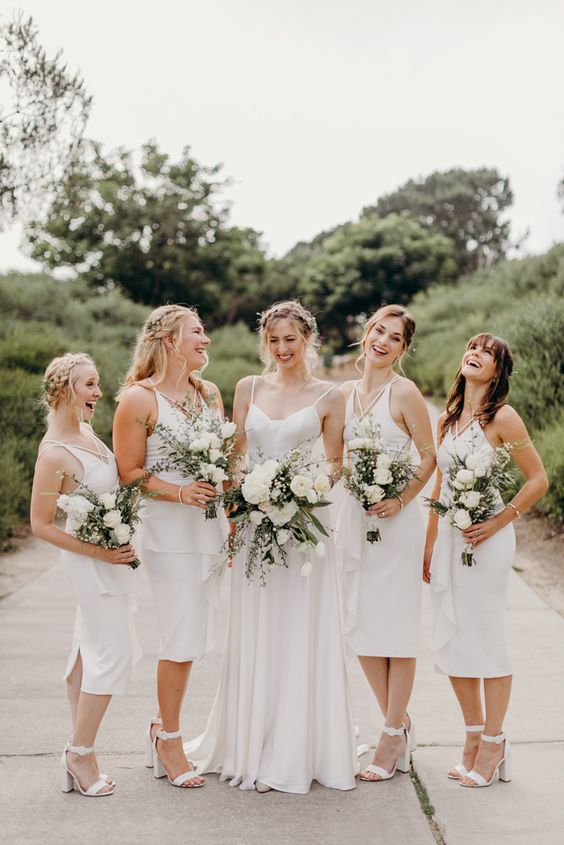 beautiful matching midi plain bridesmaid dresses with straps on the front and white shoes are amazing for a modern casual wedding