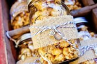jars with popcorn wrapped with burlap and with vintage keys are amazing as rustic wedding favors