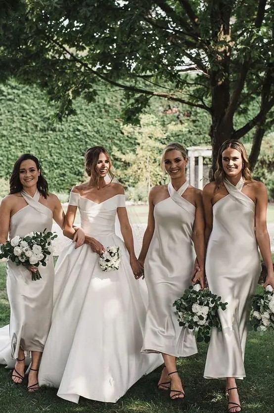 matching ivory halter neckline midi bridesmaid dresses with a hoop are a very elegant and modern idea to go for