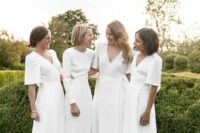 minimalist white midi bridesmaid dresses with short sleeves and V-necklines plus white and nude shoes for a minimal wedding