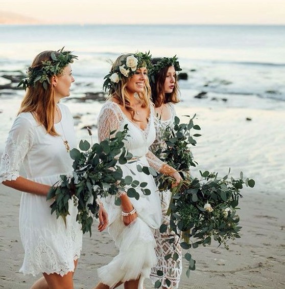 mismatched white lace dresses with a boho feel and greenery crowns for a boho beach wedding