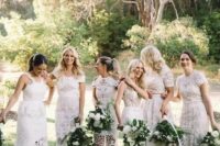 mismatching and super elegant white lace bridesmaid dresses with all kinds of designs for a glam boho white wedding