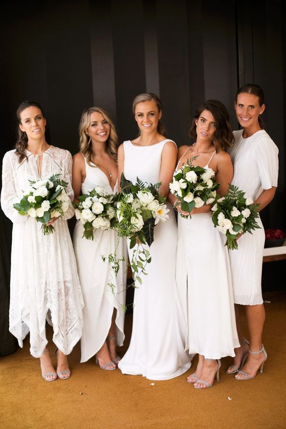 mismatching white midi and knee bridesmaid dresses plus silver heels are a great combo for a spring or summer wedding