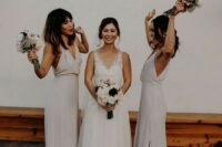 white minimalist maxi bridesmaid dresses with deep V-necklines and side slits are trendy