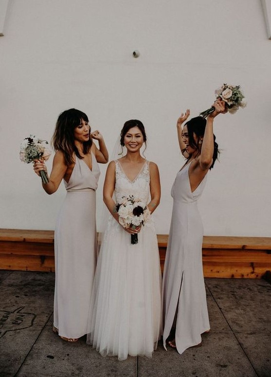 white minimalist maxi bridesmaid dresses with deep V-necklines and side slits are trendy