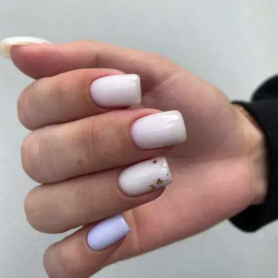 white nails plus a lilac one and a bit of gold foil for a touch of shine is a lovely idea for a spring or summer wedding