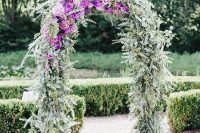 02 a beautiful wedding arch covered with eucalyptus and purple blooms is a very lovely and chic idea to rock in spring