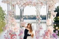 04 a breathtaking clear wedding arbor covered with ombre florals, from white to pink and red is a jaw-dropping solution