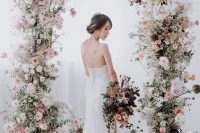 12 a fabulous and delicate spring wedding arch with white, blush and light pink blooms and greenery balanced with a bit of dark ones