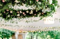 17 a refined and chic wedding chandelier of greenery, white and pink blooms and tiny candles in bubbles is amazing