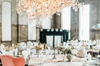 20 a beautiful overhead floral installation of blush and pink blooms and blooming branches over the table