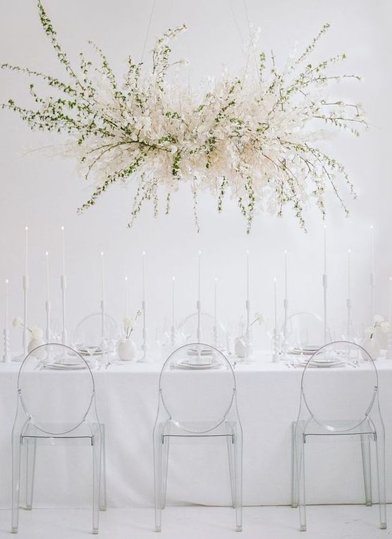an ethereal white bloom and greenery wedding installation instead of a usual wedding centerpiece