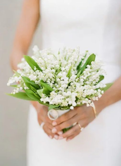 a pretty and small wedding bouquet of lily of the valley is a gorgeous and fabulous idea for a spring bride