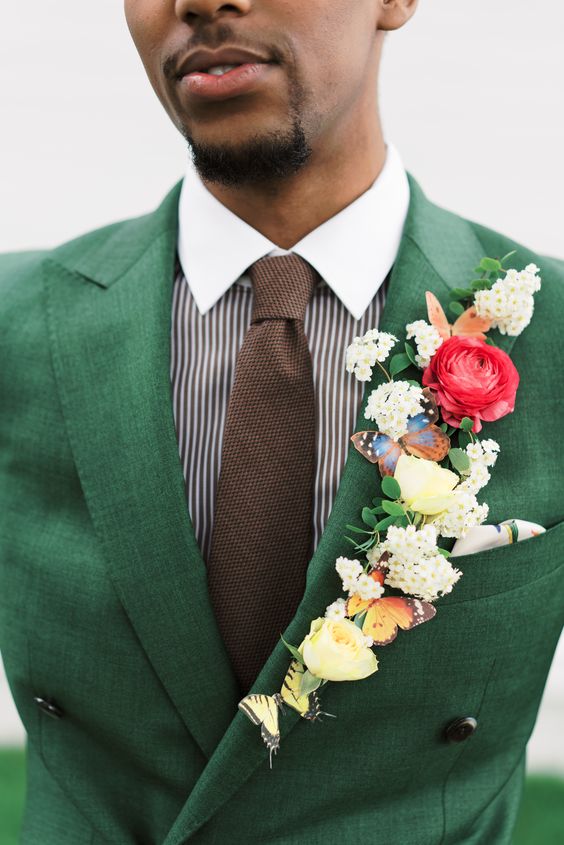 a very bold and eye-catchy floral lapel with pink and neutral blooms, greenery and faux butterflies is super creative