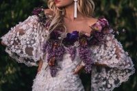 35 fresh flowers in purple and lilac covering the off the shoulder neckline for a touch of color and an unusual look