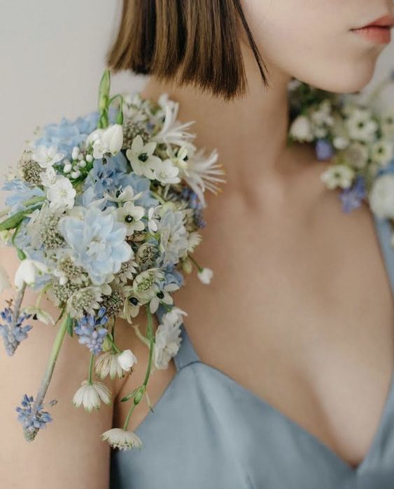 a delicate pastel blue and white cape plus some greenery is a lovely idea for a spring bride