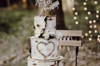 a birchbark wedding cake with a heart and a calligraphy topper is a nice piece for a rustic wedding