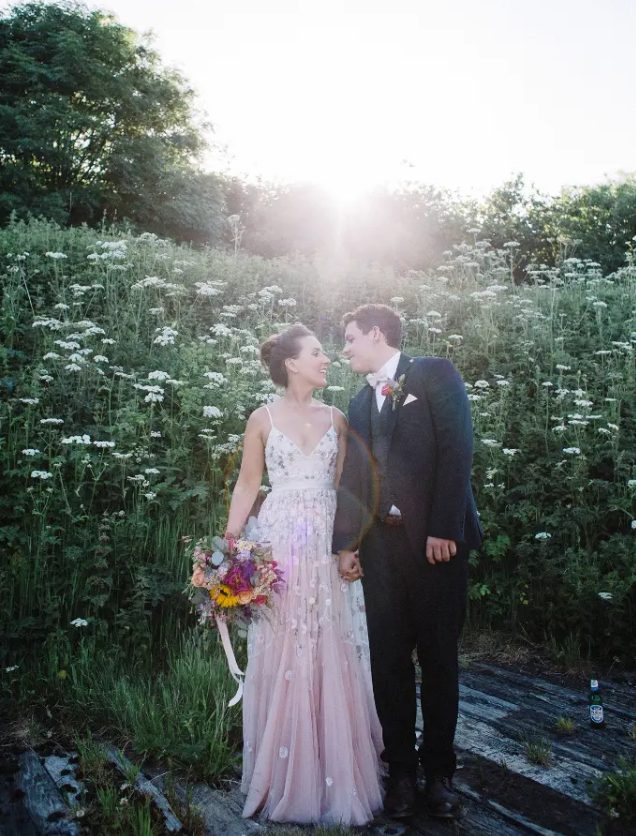 a blush A-line wedding dress with delicate and chic blush floral embroidery all over the gown and spaghetti straps for a summer wedding