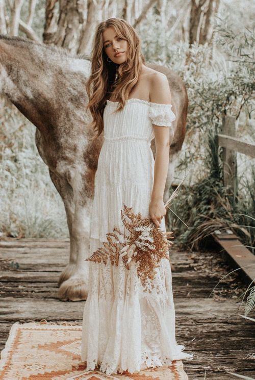 a boho chic off the shoulder empire waist wedding dress with lace looks effortless and romantic