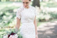 a boho lace fitting wedding dress with a high neckline, short sleeves looks bold and statement