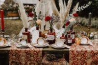 a boho table setting with printed runners, vintage tea cups, pampas grass, blooms and vintage touches